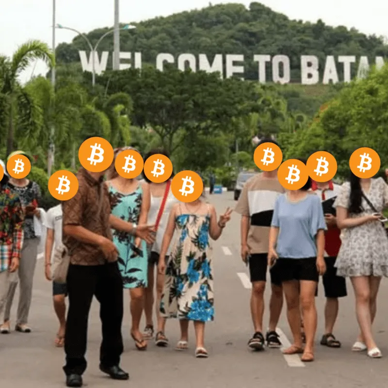 Events 34 Bitcoin Indonesia community members walking together in front of the Welcome to Batam sign, faces covered with Bitcoin logos for privacy