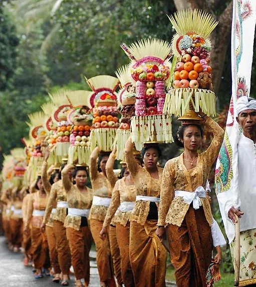 Traditional Balinese ceremony procession with women carrying decorated offerings on their heads