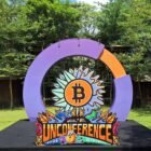 Entrance arch of the MFB Unconference 2026 in Surabaya with the Bitcoin sunflower logo
